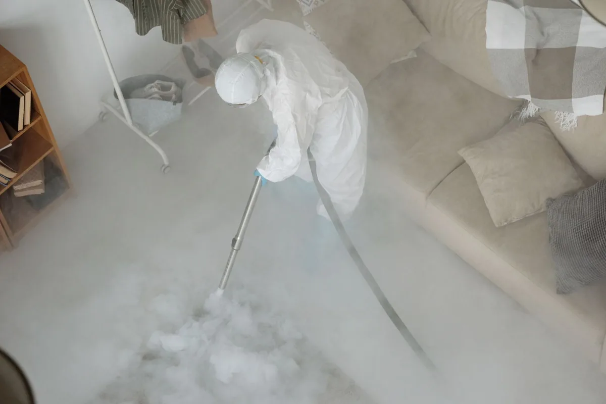 Biohazard cleanup technician in protective equipment, Huntsville, TX